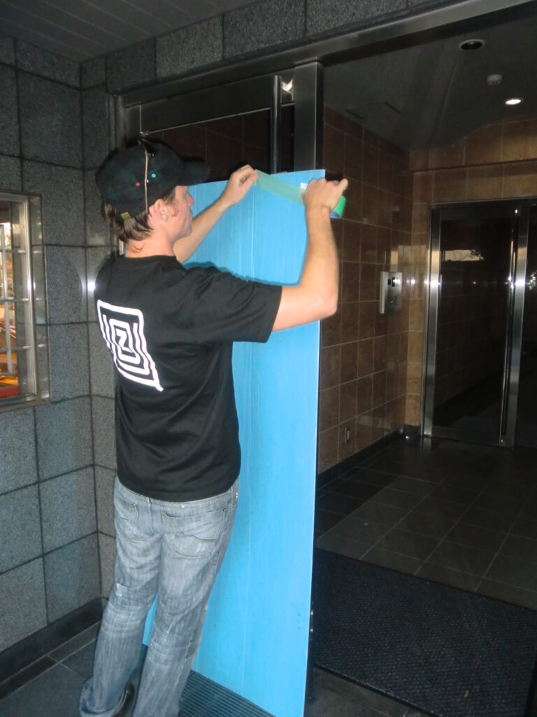 tokyo moving company preparing building protective material